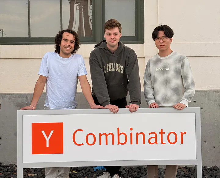 From left, Nick, Spencer, and Tiger behind the Y Combinator sign